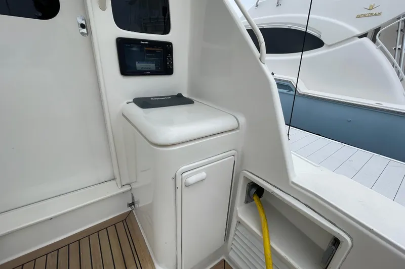 Reel It In Yacht Photos Pics 2003 Ocean Yachts 40 Super Sport cockpit with control panel and storage compartment.