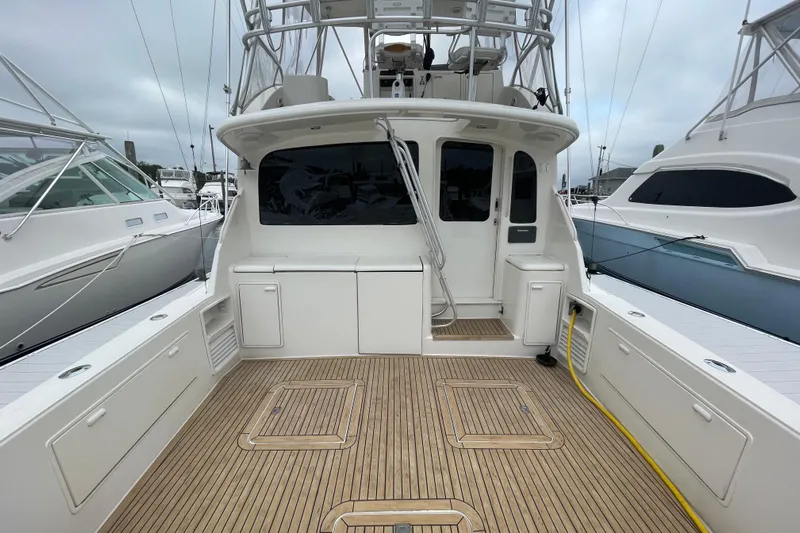 Reel It In Yacht Photos Pics 2003 Ocean Yachts 40 Super Sport boat deck with teak flooring and fishing amenities.