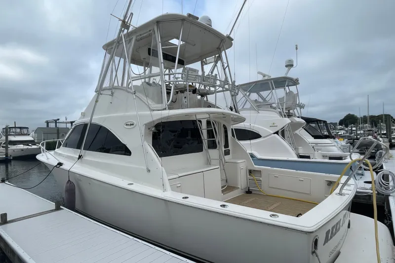 Reel It In Yacht Photos Pics 2003 Ocean Yachts 40 Super Sport docked at a marina under cloudy skies.
