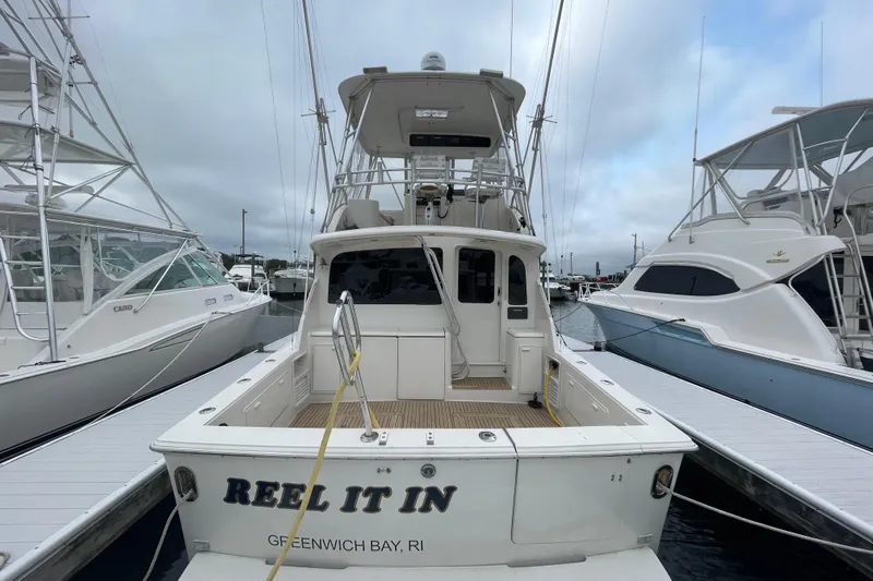 Reel It In Yacht Photos Pics 2003 Ocean Yachts 40 Super Sport docked, rear view with "Reel It In" name.