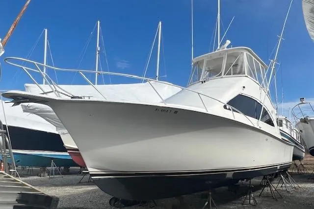 Reel It In Yacht Photos Pics 2003 Ocean Yachts 40 Super Sport boat on dry dock, surrounded by other vessels.