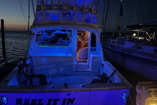 Reel It In Yacht Photos Pics 2003 Ocean Yachts 40 Super Sport illuminated at night, docked with blue lighting.