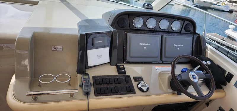  Yacht Photos Pics 2009 Sea Ray 500 Sundancer helm with navigation equipment and steering wheel.