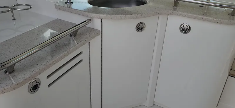  Yacht Photos Pics 2009 Sea Ray 500 Sundancer yacht interior with sleek white cabinetry and stainless steel sink.