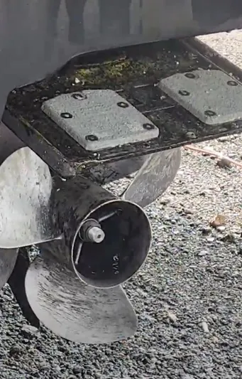  Yacht Photos Pics Propeller of 2009 Sea Ray 500 Sundancer on gravel surface.