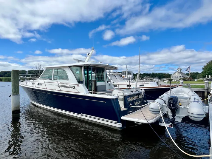 Calamity Jane Yacht Photos Pics 2018 Sabre 45 Salon Express yacht docked in a marina under a blue sky.