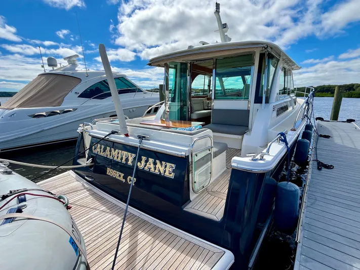 Calamity Jane Yacht Photos Pics 2018 Sabre 45 Salon Express yacht "Calamity Jane" docked under a blue sky.