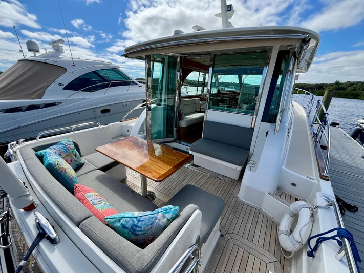 Calamity Jane Yacht Photos Pics 2018 Sabre 45 Salon Express yacht with outdoor seating and colorful cushions.