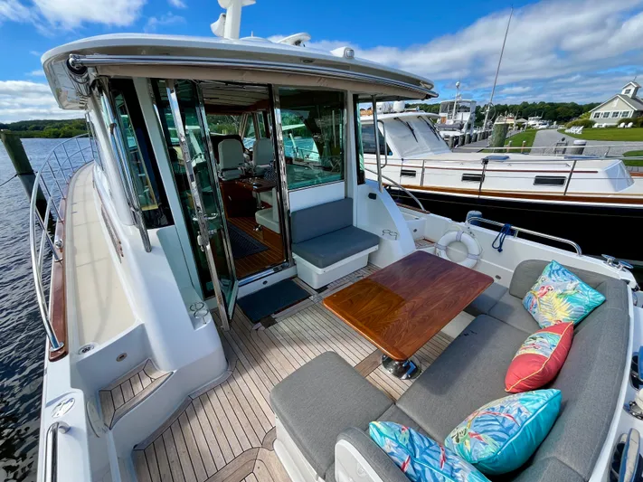 Calamity Jane Yacht Photos Pics 2018 Sabre 45 Salon Express yacht with outdoor seating and colorful cushions.