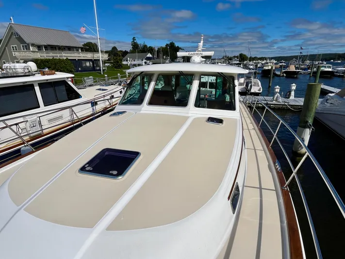 Calamity Jane Yacht Photos Pics 2018 Sabre 45 Salon Express yacht docked at marina under blue sky.