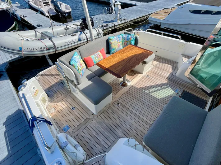 Calamity Jane Yacht Photos Pics 2018 Sabre 45 Salon Express yacht with elegant outdoor seating and wooden table.