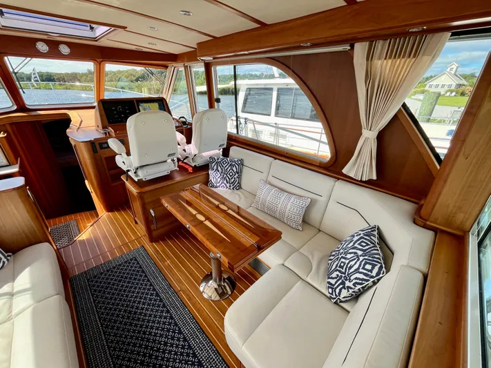 Calamity Jane Yacht Photos Pics Interior of 2018 Sabre 45 Salon Express yacht with elegant seating and wooden finishes.