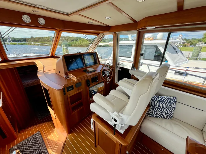 Calamity Jane Yacht Photos Pics 2018 Sabre 45 Salon Express interior with helm, leather seating, and navigation screens.