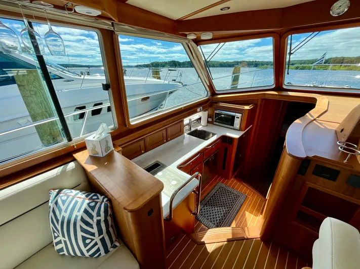 Calamity Jane Yacht Photos Pics Interior of 2018 Sabre 45 Salon Express yacht with wood finish and scenic view.
