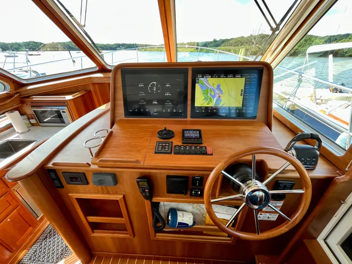 Calamity Jane Yacht Photos Pics 2018 Sabre 45 Salon Express helm with navigation screens and wooden steering wheel.