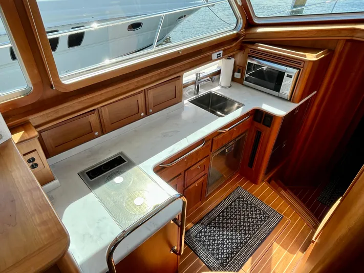 Calamity Jane Yacht Photos Pics 2018 Sabre 45 Salon Express yacht kitchen with wood cabinetry and modern appliances.