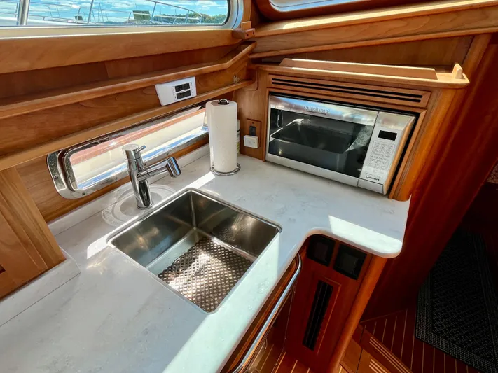 Calamity Jane Yacht Photos Pics 2018 Sabre 45 Salon Express kitchen with sink and microwave.