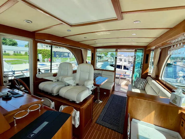 Calamity Jane Yacht Photos Pics Interior of 2018 Sabre 45 Salon Express yacht with luxurious seating and wood finishes.