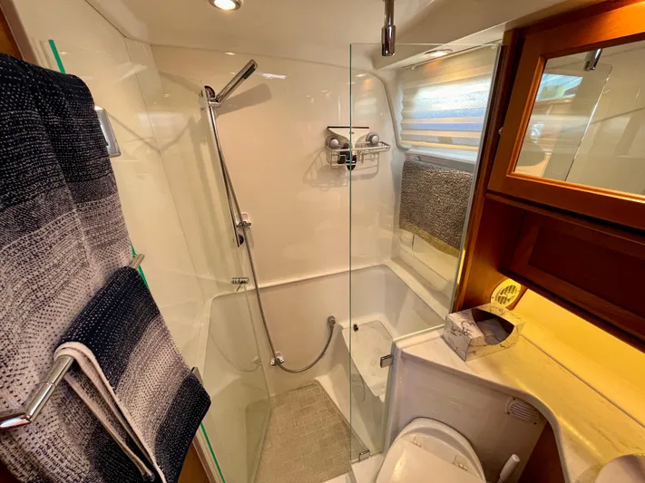 Calamity Jane Yacht Photos Pics Luxurious bathroom in 2018 Sabre 45 Salon Express yacht with modern shower and elegant fixtures.