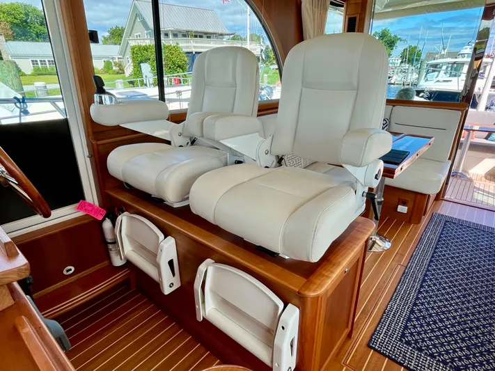 Calamity Jane Yacht Photos Pics Interior of 2018 Sabre 45 Salon Express with plush white captain chairs.