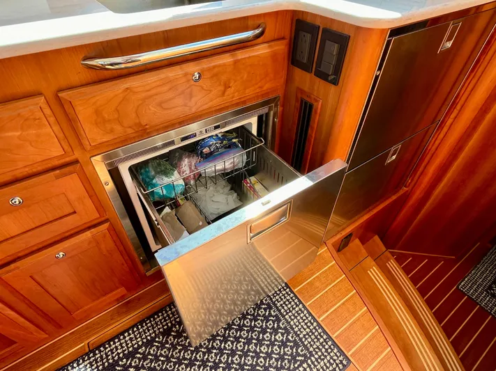 Calamity Jane Yacht Photos Pics 2018 Sabre 45 Salon Express yacht kitchen with open stainless steel drawer and wooden cabinetry.