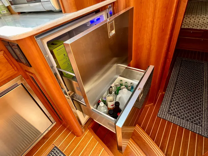 Calamity Jane Yacht Photos Pics Open drawer fridge in 2018 Sabre 45 Salon Express yacht interior, stocked with beverages.