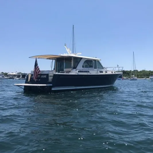 Calamity Jane Yacht Photos Pics 2018 Sabre 45 Salon Express yacht on calm water, sunny day.