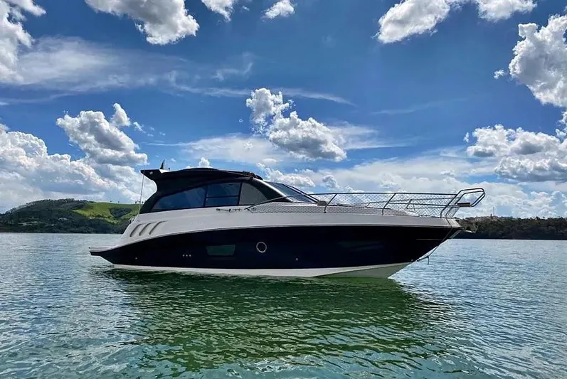  Yacht Photos Pics 2025 Hanover 355 yacht on calm water under a blue sky with clouds.