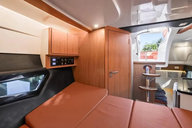  Yacht Photos Pics Luxurious interior of 2025 Hanover 355 yacht with modern wood finishes and comfortable seating.