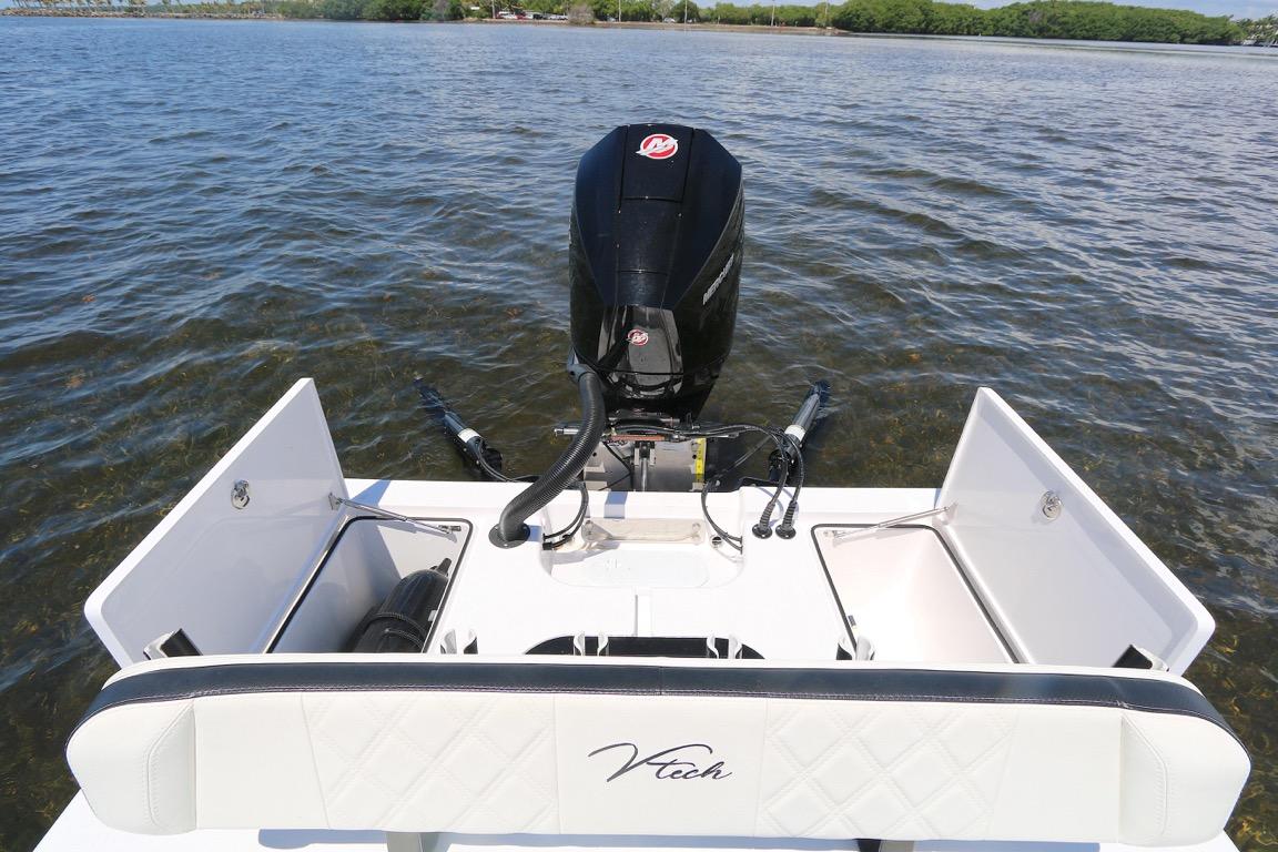 2024 Vtech 18 boat with outboard motor on calm water.