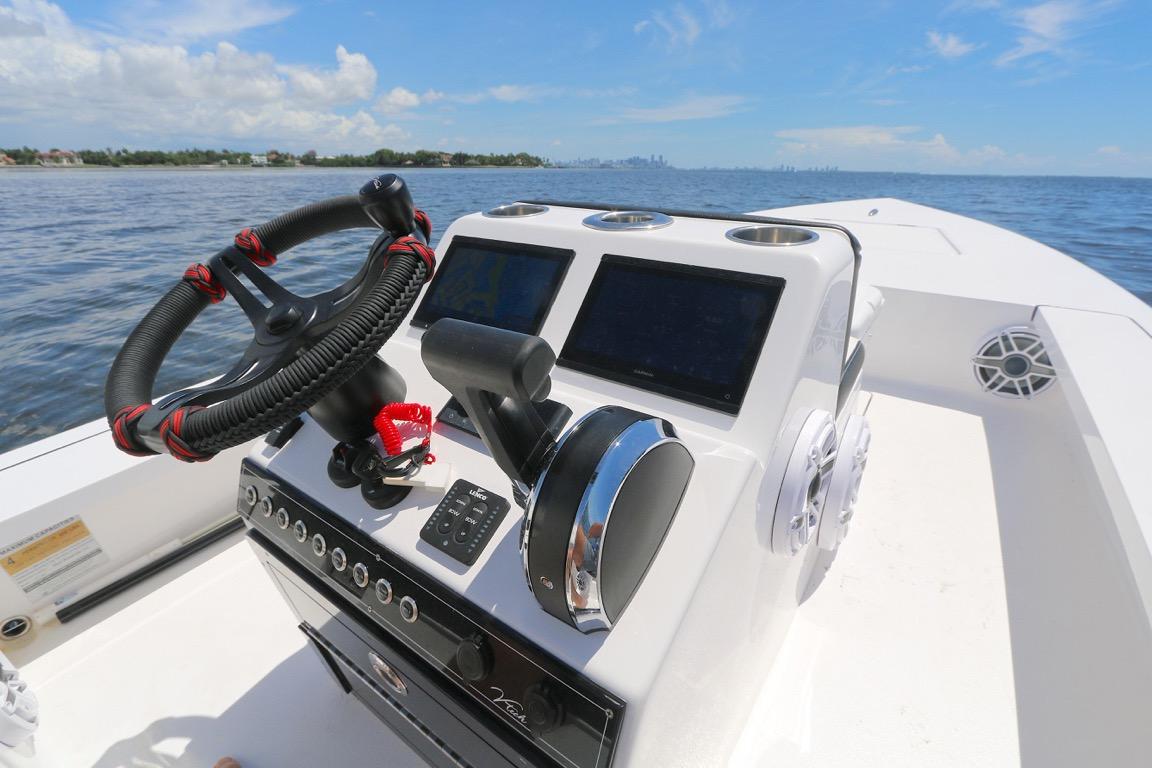 Steering console of 2024 Vtech 18 boat with modern controls on open water.