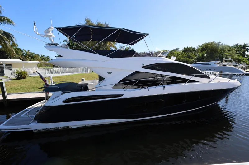  Yacht Photos Pics 2016 Sunseeker Manhattan 55 yacht docked in a serene marina setting.