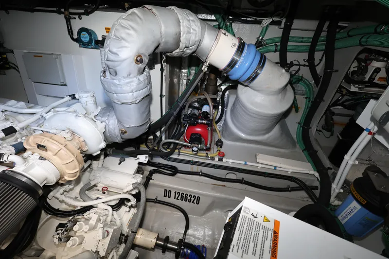  Yacht Photos Pics Engine room of 2016 Sunseeker Manhattan 55 yacht, showcasing mechanical components and piping.