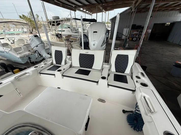  Yacht Photos Pics 2022 Tidewater 2700 Carolina Bay boat interior with seating and storage under a covered dock.