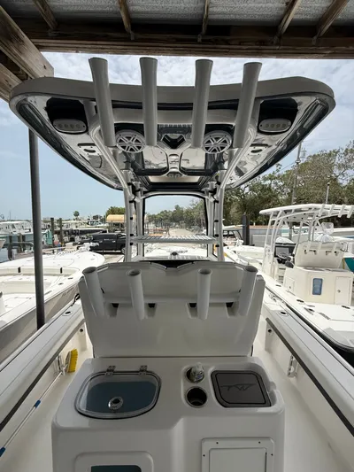  Yacht Photos Pics 2022 Tidewater 2700 Carolina Bay boat with rod holders and console, docked at marina.