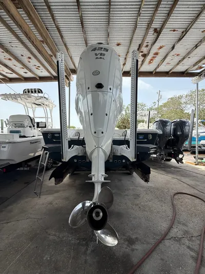  Yacht Photos Pics 2022 Tidewater 2700 Carolina Bay boat with powerful outboard motor in a covered dock.