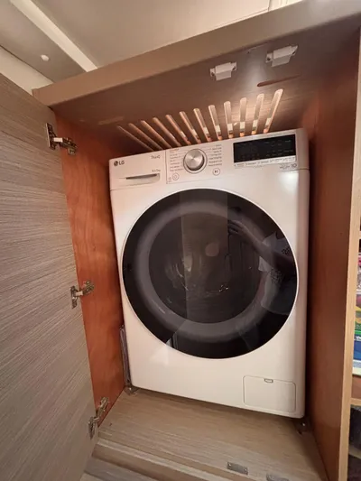  Yacht Photos Pics LG washing machine inside a 2024 Lagoon 42 yacht's wooden cabinet.