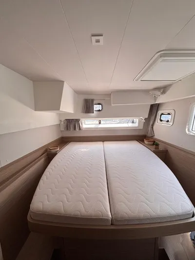  Yacht Photos Pics 2024 Lagoon 42 yacht cabin with double bed, modern design, and natural light.