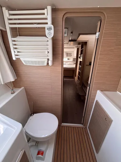  Yacht Photos Pics 2024 Lagoon 42 yacht interior bathroom with modern amenities and wooden accents.