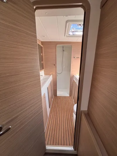  Yacht Photos Pics 2024 Lagoon 42 yacht bathroom with wood accents and modern fixtures.