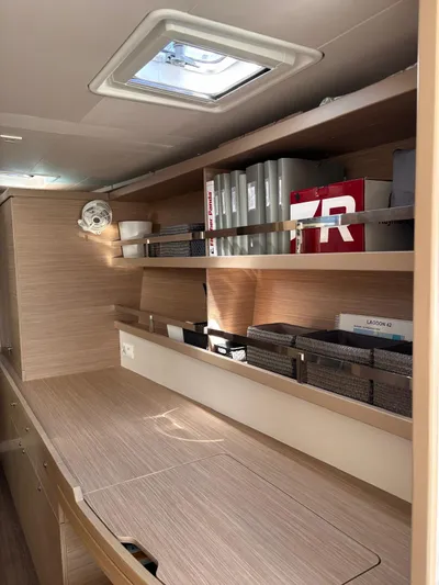  Yacht Photos Pics Interior of 2024 Lagoon 42 yacht with wooden shelves and storage compartments.