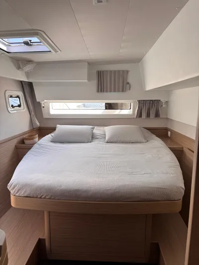  Yacht Photos Pics 2024 Lagoon 42 yacht cabin with a cozy double bed and natural light.