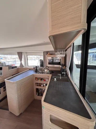  Yacht Photos Pics Modern kitchen interior of 2024 Lagoon 42 yacht with sleek countertops and ample storage.