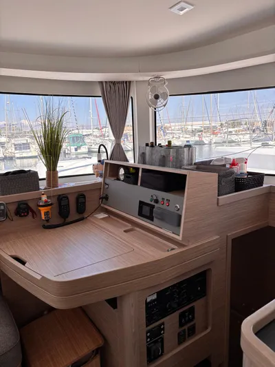  Yacht Photos Pics Interior of 2024 Lagoon 42 yacht with navigation controls and marina view.
