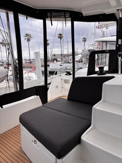  Yacht Photos Pics 2024 Lagoon 42 yacht interior with seating and marina view.