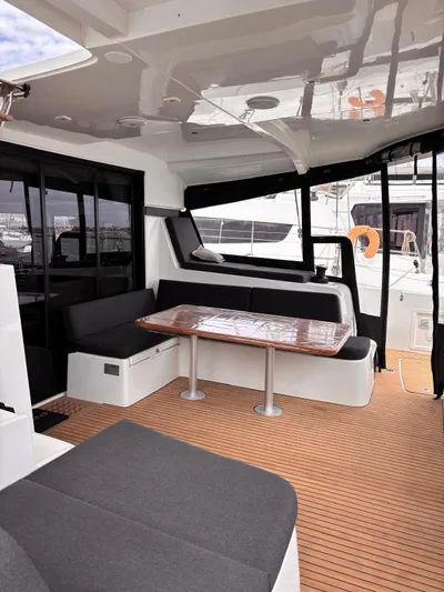  Yacht Photos Pics 2024 Lagoon 42 yacht interior with sleek seating and wooden flooring.