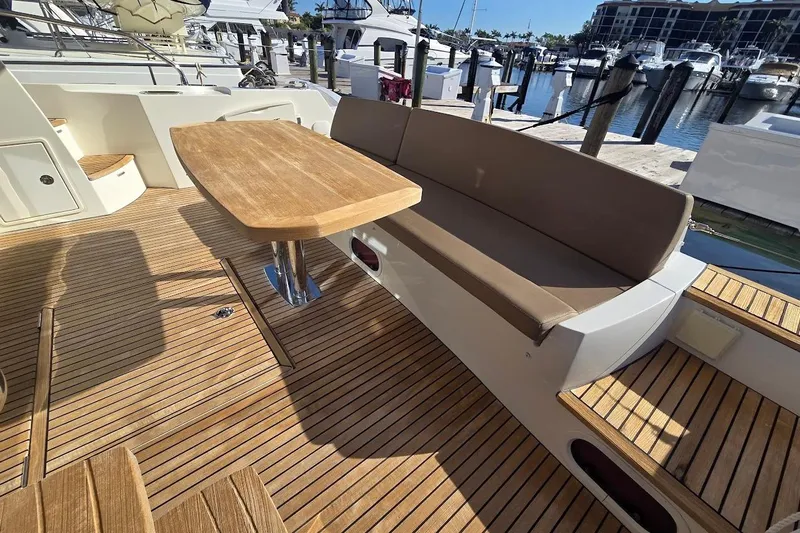 What A Day Yacht Photos Pics Luxurious 2013 Prestige 500 yacht deck with wooden table and cushioned seating.
