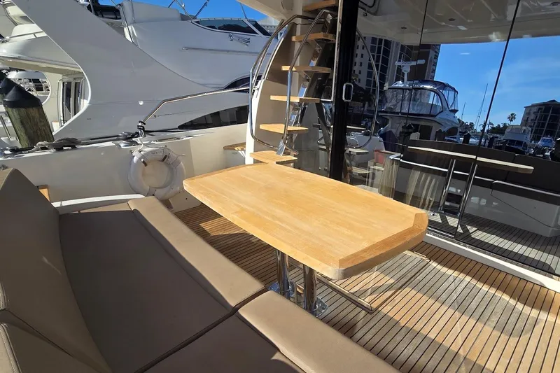 What A Day Yacht Photos Pics Prestige 500 yacht interior, 2013 model, featuring a wooden table and spiral staircase.