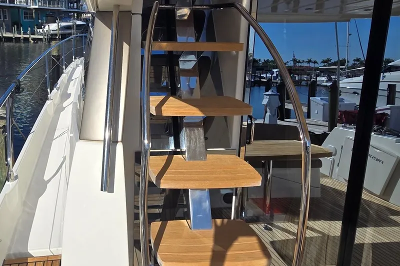 What A Day Yacht Photos Pics Staircase on 2013 Prestige 500 yacht, featuring wooden steps and sleek metal railings.