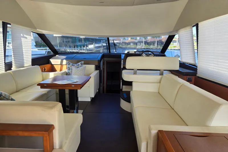 What A Day Yacht Photos Pics Luxurious interior of 2013 Prestige 500 yacht with cream leather seating and wooden table.
